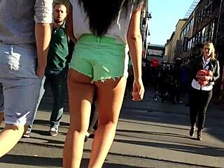 Attractive young woman in shorts strolling down the road