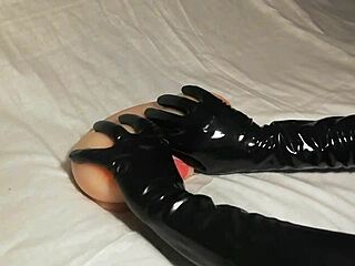 Explore sensual pleasure with black latex gloves on fake boobs